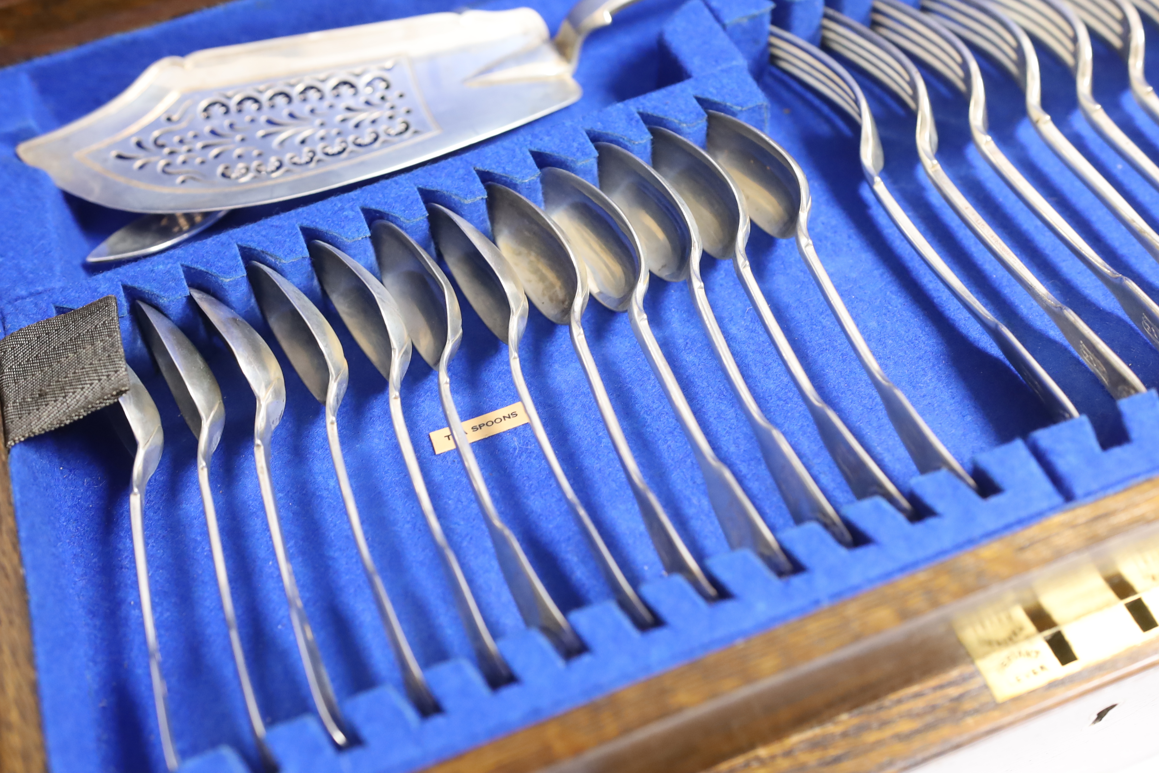 A Victorian oak cased matched canteen of silver fiddle and shell pattern flatware, by John & Henry Lias & H.J. Lias & Son